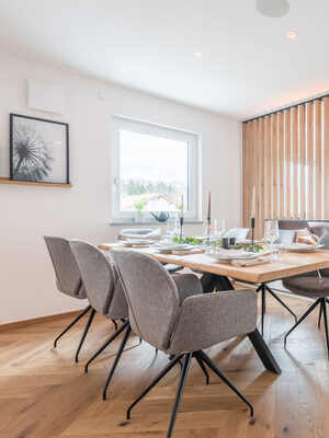 Ein großer Holztisch an dem die Mahlzeiten des Tages aus der Designküche eingenommen werden können.